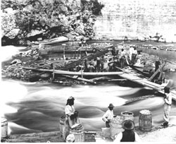 Workers building the dam across the roaring Rio Cobre River